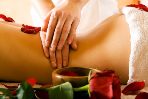 Woman Enjoying A Massage In A Spa Setting